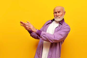 dissatisfied old bald grandfather with gray beard avoids and ignores on yellow isolated background,...