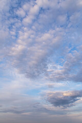 Beautiful epic soft gentle blue sky with white and grey cirrus and fluffy clouds background texture