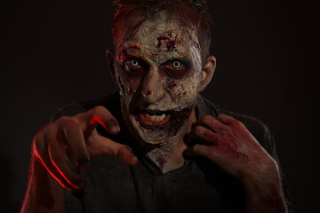 Scary zombie on dark background. Halloween monster