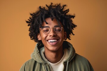 Happy joyful young African American hipster guy isolated on beige background. Smiling funny ethnic teen student, cool curly gen z fashion model laughing with dental smile white teeth, Generative AI