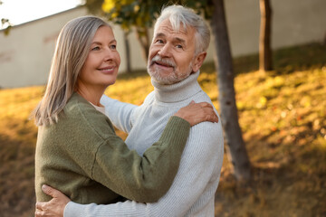 Affectionate senior couple dancing together outdoors. Romantic date