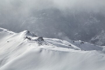 Winter high mountains in clouds