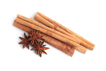 Aromatic cinnamon sticks and anise stars isolated on white, top view