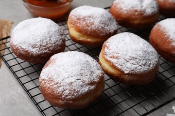 Delicious sweet buns with powdered sugar on table, closeup