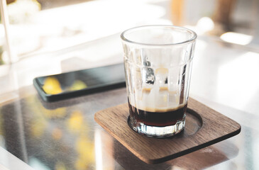 Glass with ice on table in coffee shop, stock photo