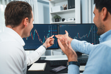 Successful stock exchange traders focusing on high profit chart investment on dynamic database,...