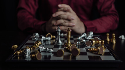 Close up of chess game with hands analyzing new strategy plan, teamwork concept, hands of businessman moving chess pieces in successful competition. Management strategy or leadership concept