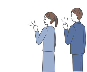 ガッツポーズをするスーツ姿の男性と女性