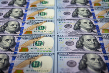 100 dollar notes background. Benjamin Franklin face portrait. Monetary wallpaper.