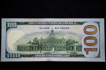 back of the 100 US dollar note on a dark background
