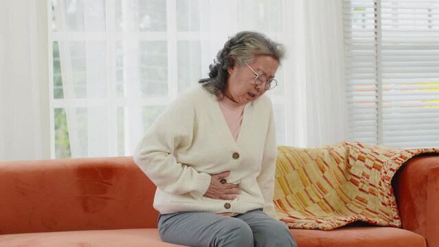 Asian Elderly senior woman stomach ache so pain illness,food poisoning in patient have a bacteria infection,Unhappy elderly painful on stomach vomit and tried need medicine and rest,Elderly Health
