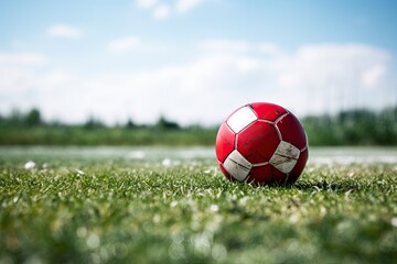 A soccer ball is present on the football field