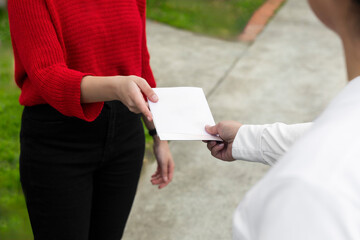 Hands Exchanging a Blank Leaflet