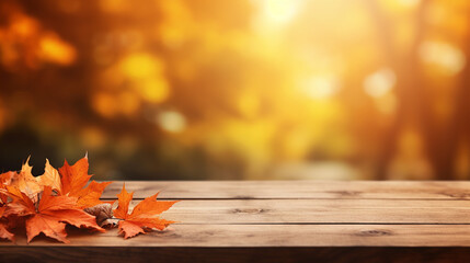 Naklejka na ściany i meble wooden table with orange leaves and blurred background and sunlight