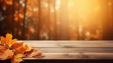 Poster wooden table with orange autumn leaves background © Aura