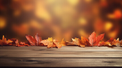 Naklejka na ściany i meble wooden table with orange autumn leaves blurred background