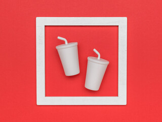 Fototapeta premium Two drinks glasses in a frame on a red background.