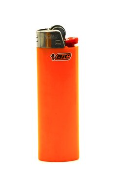Orange colored BIC cigarette lighter isolated on white