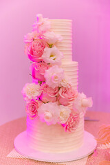 Beautiful white wedding cake decorated with flowers 