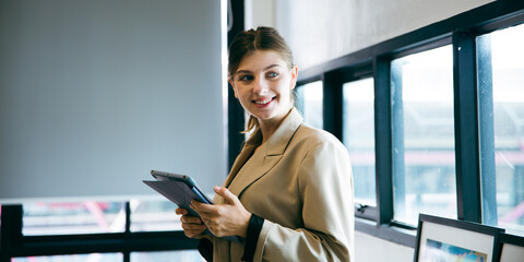 Fototapeta premium Confidence businesswoman female Caucasian manger is having a vision and ideas while working with digital tablet. Portrait of beautiful executive or employees work at company indoor office cyberspace