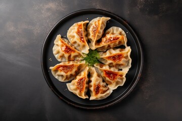 Top view of gyoza dumplings on a plate gray concrete background