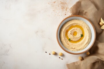Top view of hummus on a light table in the kitchen - obrazy, fototapety, plakaty