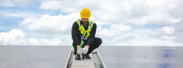 Professional engineer or expert technician is fixing and used electric drill securing solar panel...
