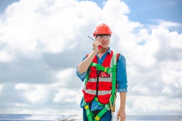 A Professional engineer or expert technician using radio communication or walkie-talkie to order...