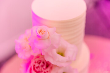 Beautiful white wedding cake decorated with flowers 