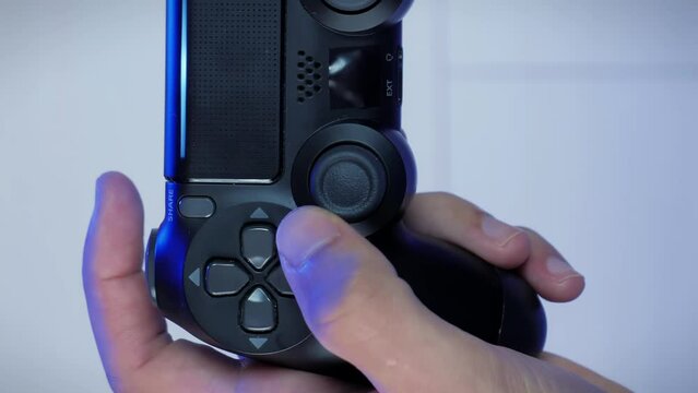 Hands holding joystick controller, pressing and pushing buttons. Vertical video