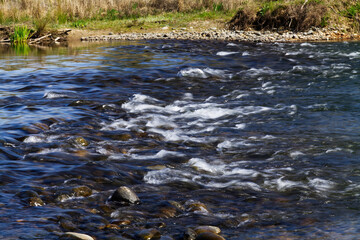 Small Rapids In River With Far Bank