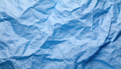 Obraz premium The blue crumpled paper background.