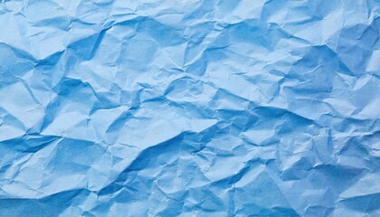 Obraz premium The blue crumpled paper background.