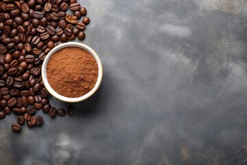 Ground coffee in bowls with roasted beans on a concrete background seen from above