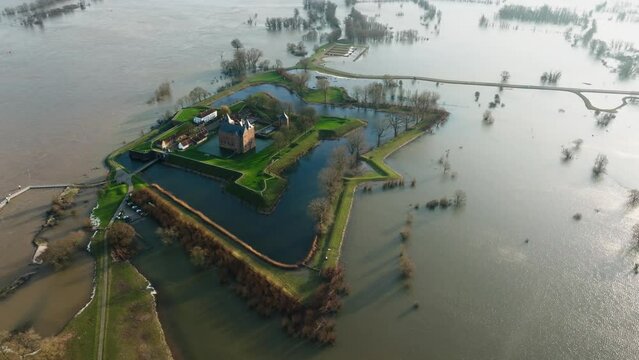 Overflown banks of river Waal cause big flooding around Loevestein castle. Drone