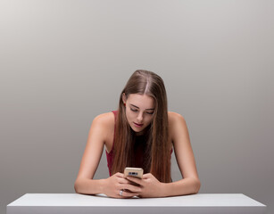 Woman absorbed in smartphone, concentration deeply evident