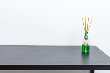 Black table with air freshener and white background. Copy space.