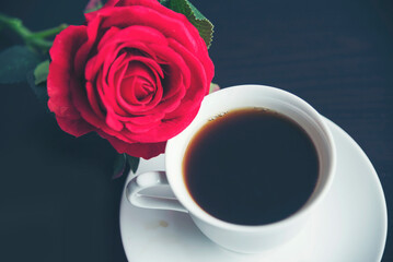 Tabletop black coffee cup red rose on wood table background with empty copy space. Espresso shot caffeine hot coffee cup in cafe. Top view Black caffeine dark beverage in cafeteria with copy space