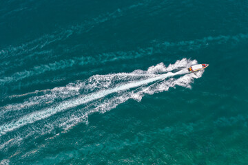 High speed boat rushing along the water surface of warm tropical waters, transfer of tourists....