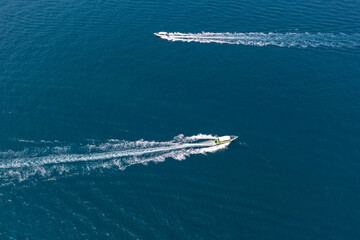 Two traffic flow of speedboats in the strait between tropical exotic islands, boats ply intensively...