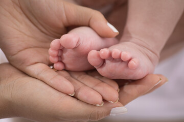 Obraz na płótnie Canvas Newborn soft baby feet body part delicate motherhood 