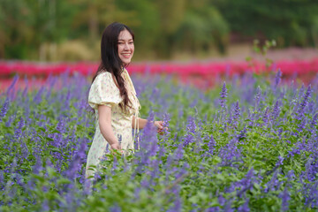 beautiful woman in dress enjoying blooming lavender flower field