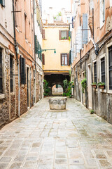 Fototapeta na wymiar Looking down the narrow streets or alley of Venice