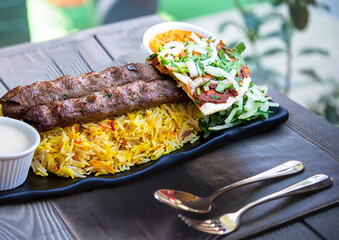 grilled kebab with Mandi rice on a wooden table