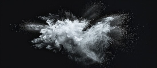 Pause movement of white powder explosion on dark backdrop.