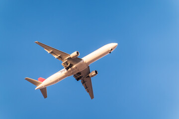 Airplane before landing in blue sky, Airbus A330