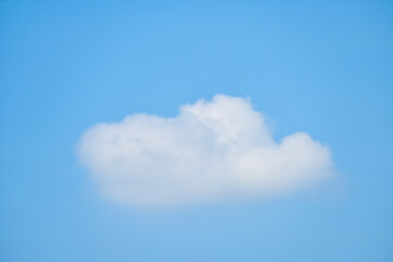 beautiful blue sky and white fluffy single cloud with sunrise in the morning, natural background