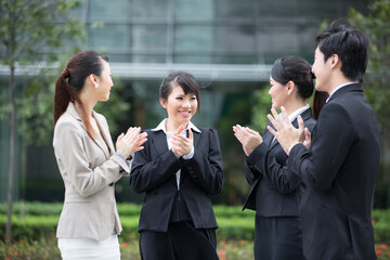 Business team applauds each other.