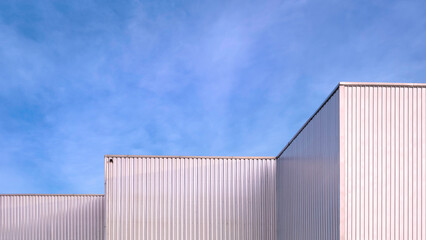 Fototapeta na wymiar Aluminum Corrugated Industrial Factory Buildings in modern style against blue sky Background, Perspective view