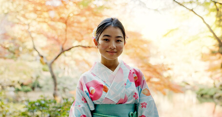 Culture, park and portrait of Japanese woman for wellness, fresh air and relax outdoors in nature....